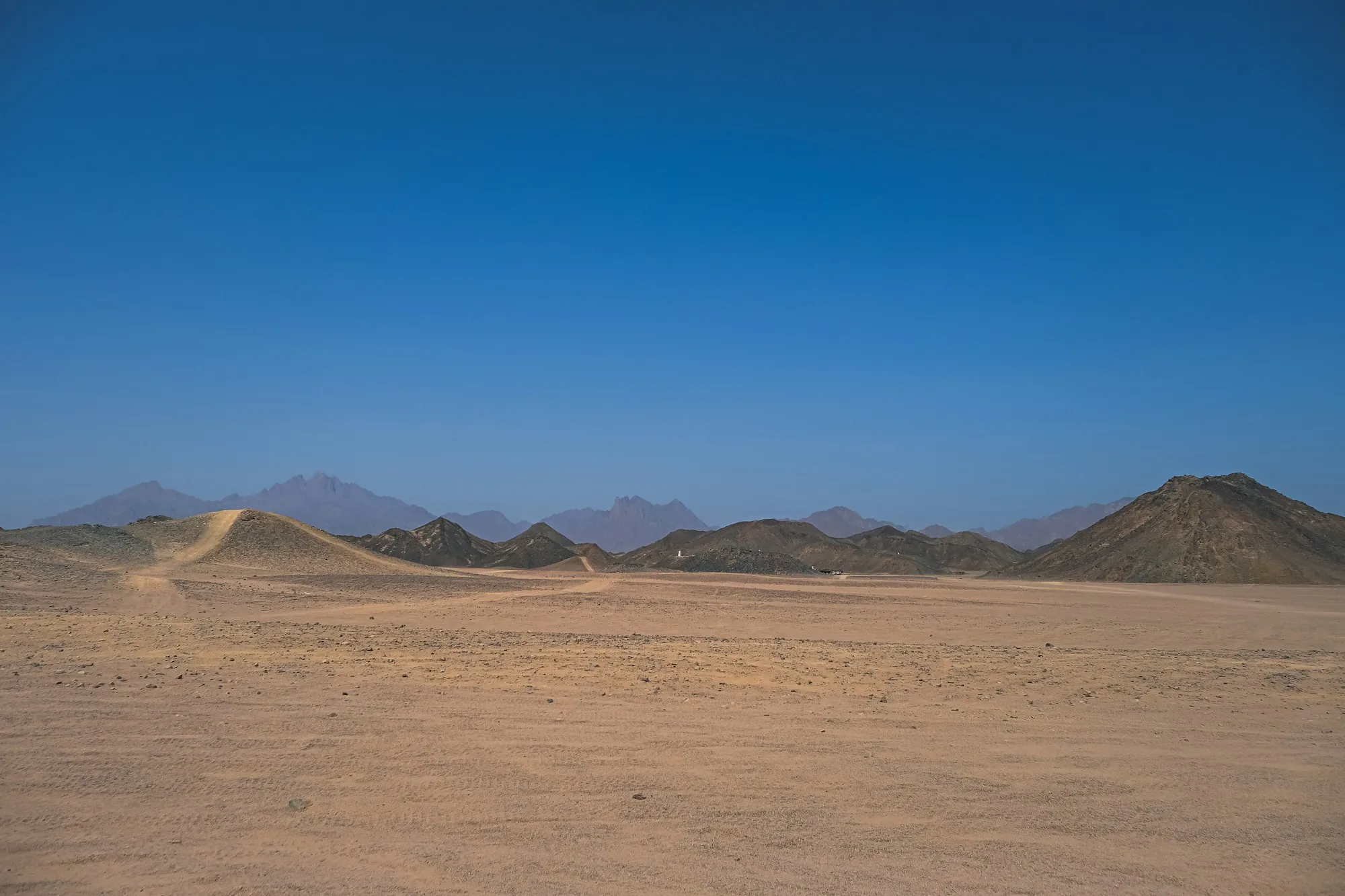 Flat desert basin with distant mountains